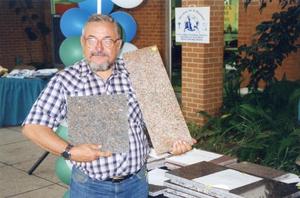 Michael Jones, Lee College geology instructor, displays some of the cutting slabs on sale to raise funds during "Services for a Purpose".