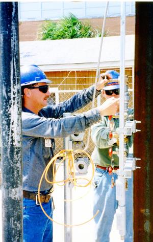 Instrumentation: Industrial pilot plant, Employees of Kvaerner John Brown, instrument fitters Royce Boykin, left, and Casey Brumley, install an air header