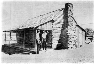Torian Log Cabin with Two Men on Front Porch