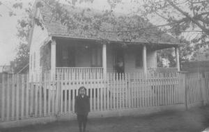 Primary view of object titled '[The McNabb house. One story, white, wooden house.]'.