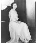Photograph: Unidentified Woman Seated on Piano Bench