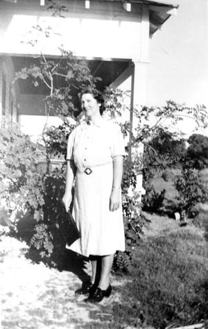 Willie Hazel Anderson Standing in Front of Moss Rose Bush