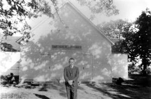 Reginald Anderson Standing in Front of Isham's Chapel