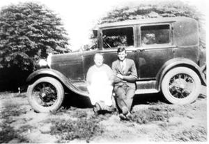 Primary view of object titled 'Reginald and Virginia Walker Anderson Sitting on the Running Board of Reginald's New Car'.