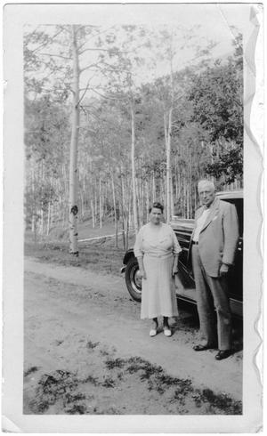 [Col. Hugh B. and Helen Moore standing on a road near Santa Fe, New Mexico]
