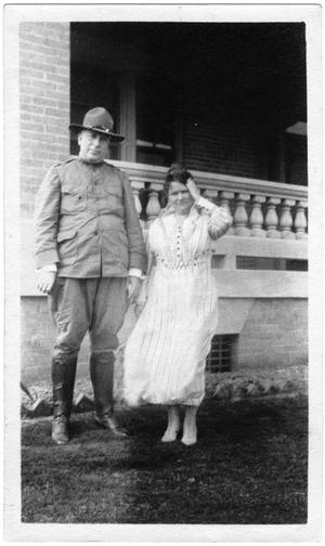 [Col. Hugh B. Moore in uniform and Helen Moore in front of their home]