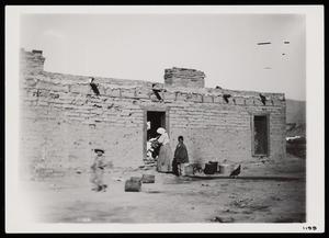 [Photograph of Adobe House with Family]