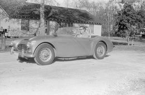 Primary view of object titled '[Gene Cotton and his Austin-Healy Sprite]'.