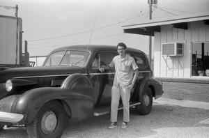 [David Lewis Posing with an Antique Car]