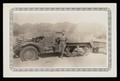 Photograph: [Soldier Posing with Half-Track Vehicle]
