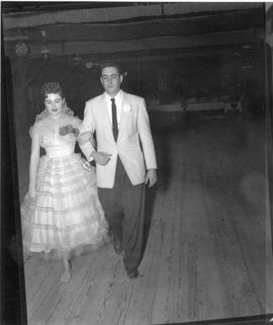 Primary view of object titled '[Couple Walking During County Fair Pageant]'.