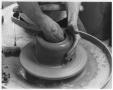 Thumbnail image of item number 1 in: 'Student Working a Pot on a Potter's Wheel'.