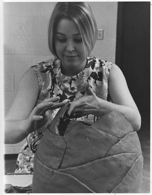 Primary view of object titled 'Student Working on a Pot in Ceramics Class'.