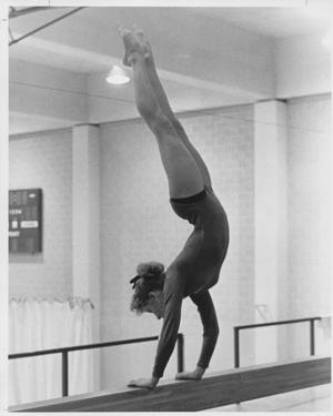 Primary view of object titled 'Gymnastics Student Performing Handstand on Balancing Bar'.