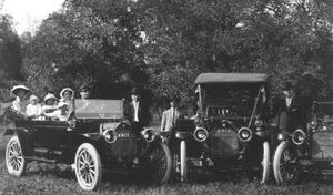 Primary view of object titled '[Family Photo with Two Cars]'.