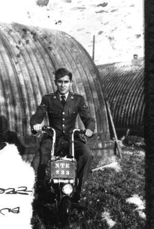 Primary view of object titled '[Man on Scooter at a Military Base]'.