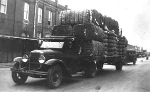 [Truck loaded with cotton bales]