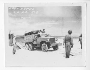 [Servicemen Offloading a Truck from a Higgins Boat Onshore]