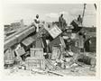Primary view of [Men Sitting on Badly Stacked Cargo at Yellow Beach, Okinawa]