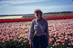 Primary view of object titled '[Woman Standing in Front of Tulips]'.