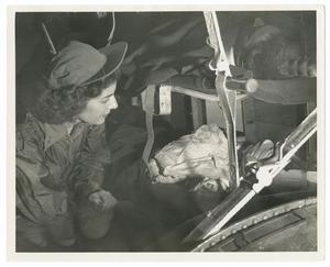 Primary view of object titled '[Jane Kendeigh with Injured Soldier on Flight]'.