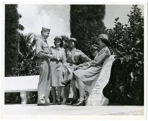 [Members of the Women's Auxiliary Corps Laughing With Officers]