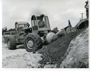 Primary view of object titled 'A digging machine that can dig its way right up a straight bank J5G, Photo 17, L-7395'.