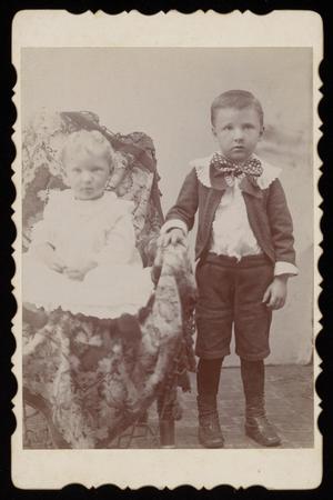 [Portrait of Two Unknown Children With a Chair]