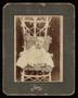 Photograph: [Unknown Child Sitting in a Wicker Chair]