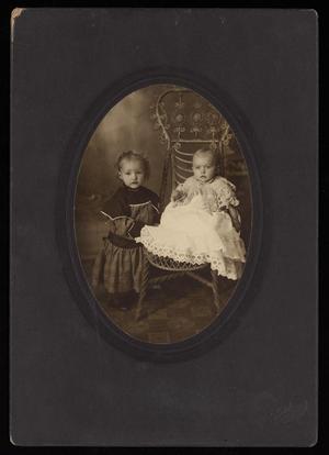 [Portrait of Two Unknown Children with a Wicker Chair]