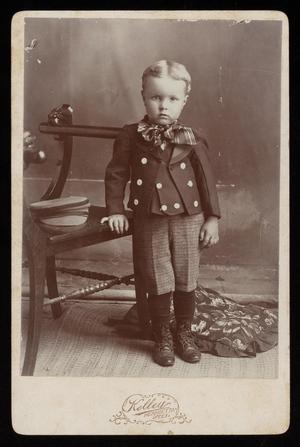 [Portrait of a Young Boy Next to a Chair]