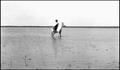 Photograph: [A boy on horseback in a playa lake]
