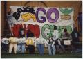 Photograph: [Students hang Homecoming sign on Bruce Hall #2]
