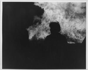 Primary view of object titled '[Man silhouetted against North Texas Homecoming bonfire, c. 1980]'.