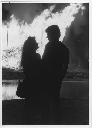 Primary view of object titled '[Couple silhouetted against North Texas Homecoming bonfire, c. 1980]'.