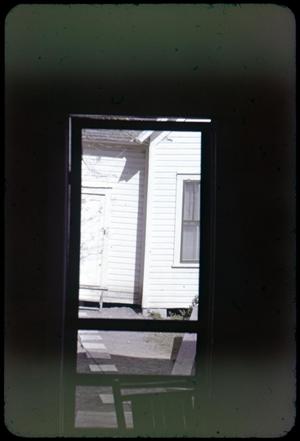 [Photograph of Exterior through Screen Door]