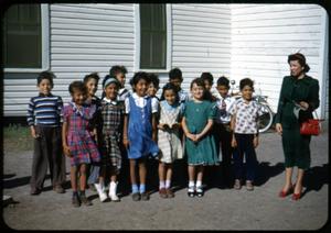 [Photograph of Children in Front of a White Building]