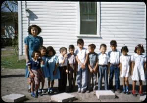 [Photograph of Children in Front of White Building]