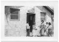 Photograph: [Teacher and Students Outside of School House]
