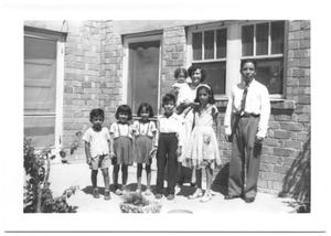 [Hispanic Family in Front of a Brick Building]