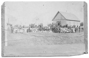 [Large Formal Group Portrait in Front of a Large Wood Building]