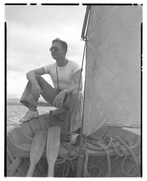 [Negative of a Sailor Sitting on Edge of a Boat]