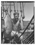 Photograph: [Negative of a Man in Underwear Holding a Fish]