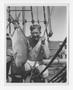 Photograph: [Man in Underwear Holding a Fish]