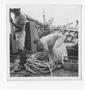 Photograph: [Sailor Lifting Ropes on Board the Evaleeta]