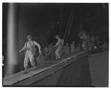 Photograph: [Negative of Soliders Hauling Packs of a Ship at Night]