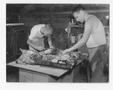 Photograph: [Two Men Preparing Meat]
