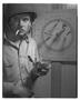 Photograph: [Negative of Soldier Smoking by Dart Board, #2]