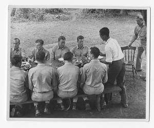 [Servicemen Having Lunch Around Picinic Table]