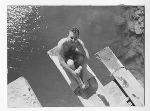 [Man Sits on Diving Board]